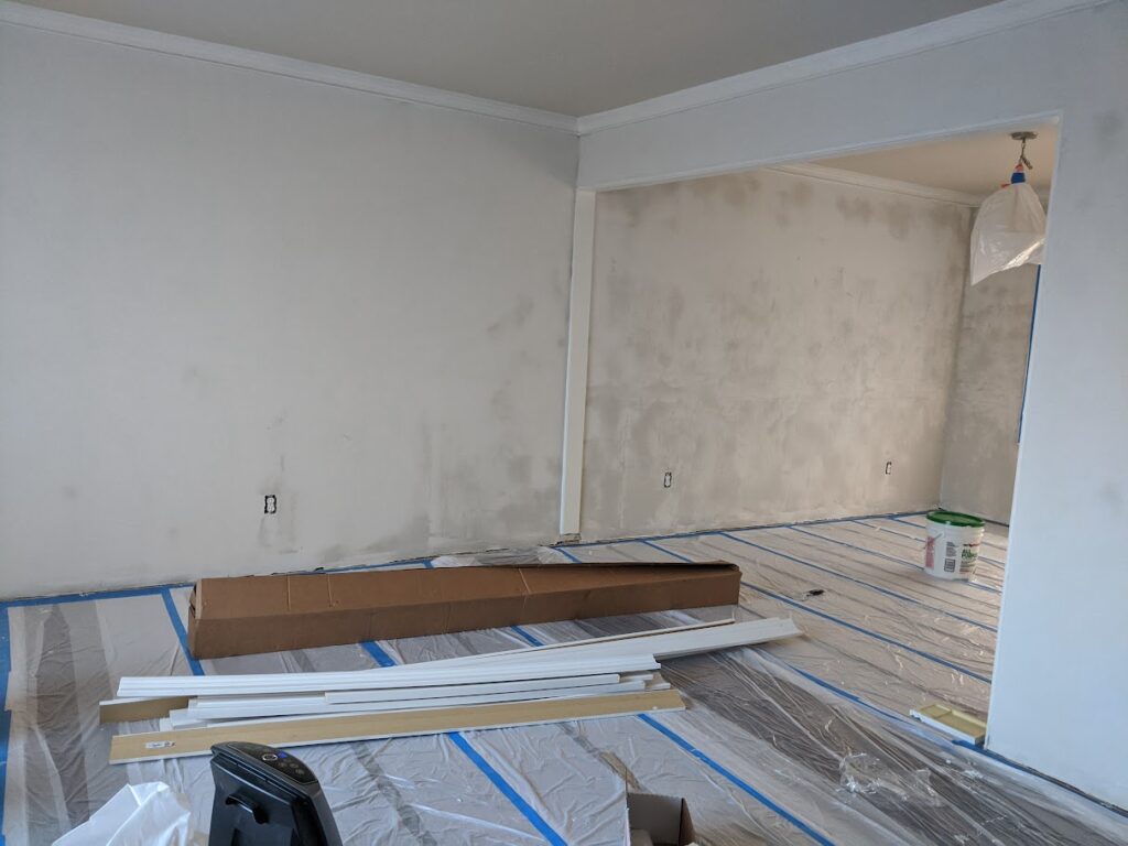 Living Room and Dining Room Mudded the walls joint compound to start smoothing the walls